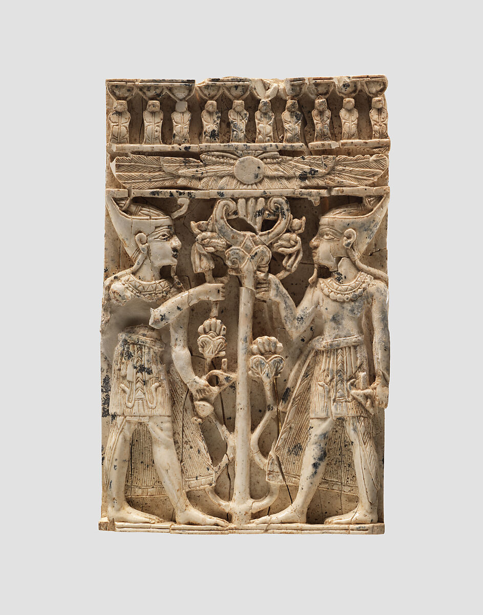 Furniture plaque carved in high relief with two Egyptianizing figures flanking a volute tree, Ivory, Assyrian