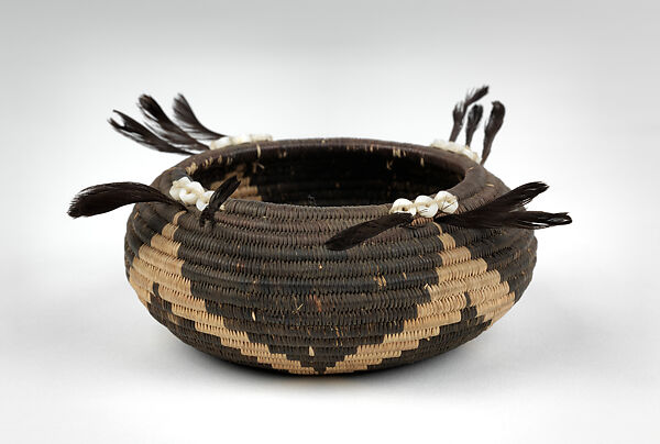 Three-rod coiled negative basket, Willow shoot foundation, sedge root weft, dyed bulrush root weft, feathers (California valley quail topknots), clamshell disk beads, and cotton string, Big Valley Pomo (Lake County, California)